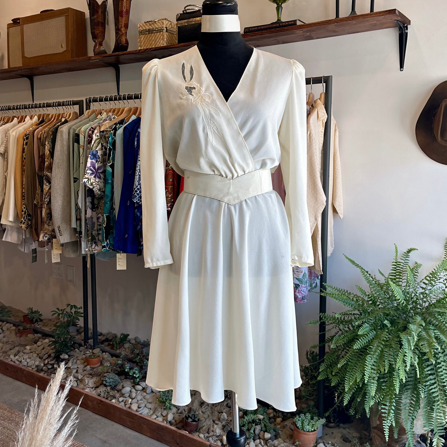 Authentic vintage 1970s dress by Jody of California. Features sheer floral bust, blouson sleeves, silk-like fabric, and optional waist belt. Fits XS–S.